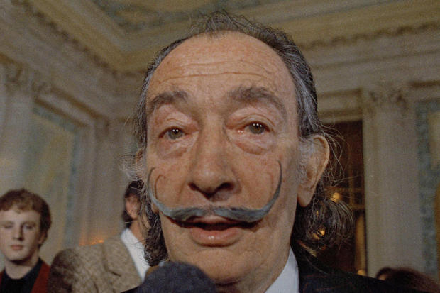FILE - In this May 21, 1973 file photo, Spanish surrealist painter Salvador Dali, presents his first Chrono-Hologram in Paris, France. A Spanish judge on Monday June 26, 2017, has ordered the remains of artist Salvador Dali to be exhumed following a paternity suit by a woman named by Europa Press agency as Pilar Abel, 61 from the nearby city of Girona. Dali, considered one of the fathers of surrealism in art, died in 1989 and is buried in his museum in the northeastern town of Figueres. (AP Photo/Eustache Cardenas, File)
