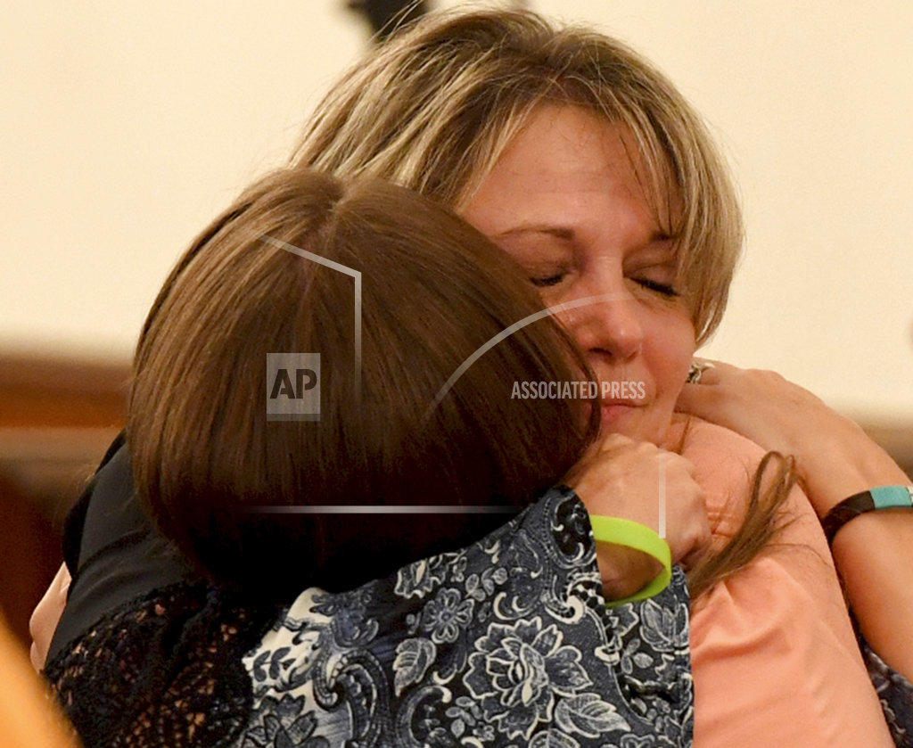 Karen Bobo, right, mother of Holly Bobo, receives a hug from a supporter after a court recess was called Friday, Sept. 22, 2017, in Savannah, Tenn. A Hardin County jury found Zachary Adams guilty Friday of kidnapping, raping and murdering Holly Bobo. (Kenneth Cummings/The Jackson Sun via AP)