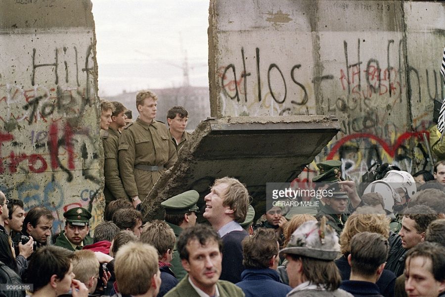 West Berliners crowd in front of the Berlin Wall early 11 November 1989 as they watch East German border guards demolishing a section of the wall in order to open a new crossing point between East and West Berlin, near the Potsdamer Square. Two days before, Gunter Schabowski, the East Berlin Communist party boss, declared that starting from midnight, East Germans would be free to leave the country, without permission, at any point along the border, including the crossing-points through the Wall in Berlin. The Berlin concrete wall was built by the East German government in August 1961 to seal off East Berlin from the part of the city occupied by the three main Western powers to prevent mass illegal immigration to the West. According to the August 13 Association which specialises in the history of the Berlin Wall, at least 938 people - 255 in Berlin alone - died, shot by East German border guards, attempting to flee to West Berlin or West Germany. AFP PHOTO / GERARD MALIE (Photo credit should read GERARD MALIE/AFP/Getty Images)