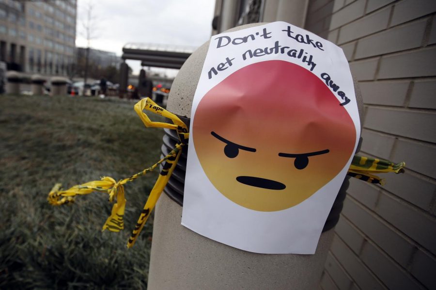 A sign with an emoji reads Dont take net neutrality away is posted outside the Federal Communications Commission (FCC), in Washington, Thursday, Dec. 14, 2017, Thursday, Dec. 14, 2017. The FCC voted to eliminate net-neutrality protections for the internet. (AP Photo/Carolyn Kaster)