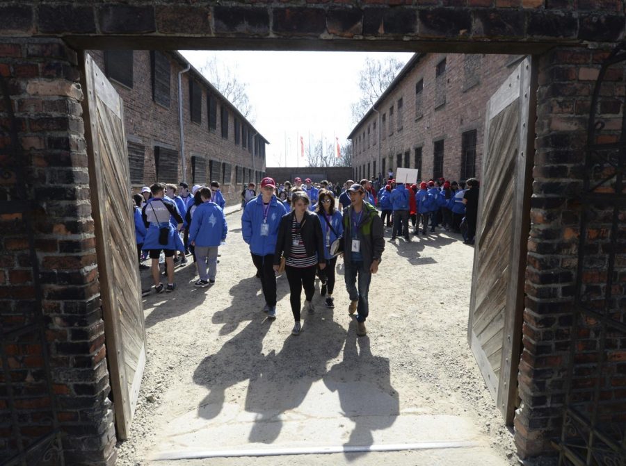 A group of young Jews visits the Death Wall at the former Nazi German death camp of Auschwitz ahead of the yearly March of the Living, a Holocaust remembrance march, in Oswiecim, Poland, on Thursday April 12, 2018. (AP Photo/Czarek Sokolowski)