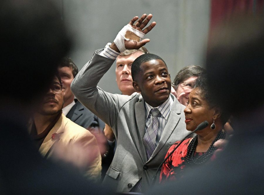 FILE - In this Tuesday, April 24, 2018, file photo, James Shaw Jr. waves to the crowd and legislators inside the Tennessee House chambers at the Tennessee State House in Nashville, Tenn., as he is honored for disarming a shooter inside an area Waffle House. The White House says President Donald Trump has spoken with 29-year-old James Shaw Jr., a Tennessee man who wrestled a rifle away from a gunman at a Nashville Waffle House. (Larry McCormack/The Tennessean via AP, File)