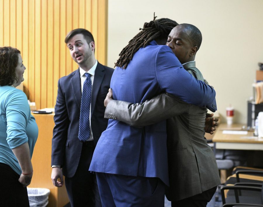 A.J. Johnson, left, and Michael Williams hug after a jury acquitted them of aggravated rape charges Friday, July 27, 2018, in Knoxville, Tenn. Johnson and Williams were indicted on February 2015 after a woman said both men raped her during a party at Johnsons apartment in the early morning hours of Nov. 16, 2014. Johnson and Williams were suspended from the Tennessee football team less than 48 hours after the party and never played for Tennessee again. (Michael Patrick/Knoxville News Sentinel via AP)