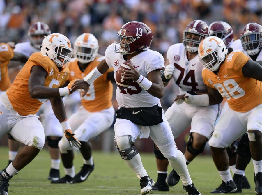 Tennessee defensive lineman Kyle Phillips (5) and Tennessee defensive lineman Alexis Johnson Jr. (98) go after Alabama quarterback Tua Tagovailoa (13) during the first half of an NCAA college football game, Saturday, Oct. 20, 2018, in Knoxville, Tenn. (Joy Kimbrough /The Daily Times via AP)