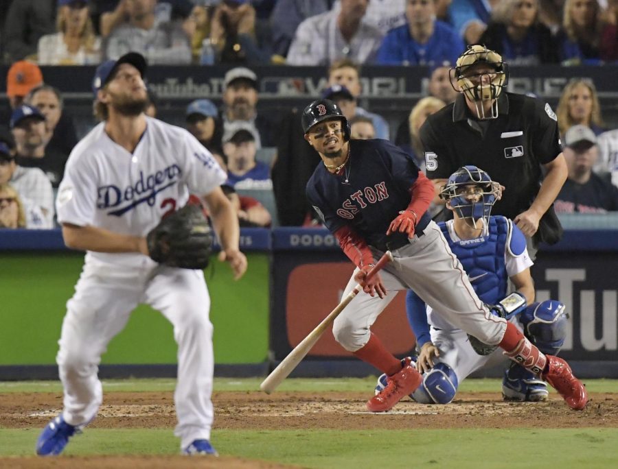 Boston Red Soxs Mookie Betts, right, watches his home run off Los Angeles Dodgers starting pitcher Clayton Kershaw during the sixth inning in Game 5 of the World Series baseball game on Sunday, Oct. 28, 2018, in Los Angeles. (AP Photo/Mark J. Terrill)