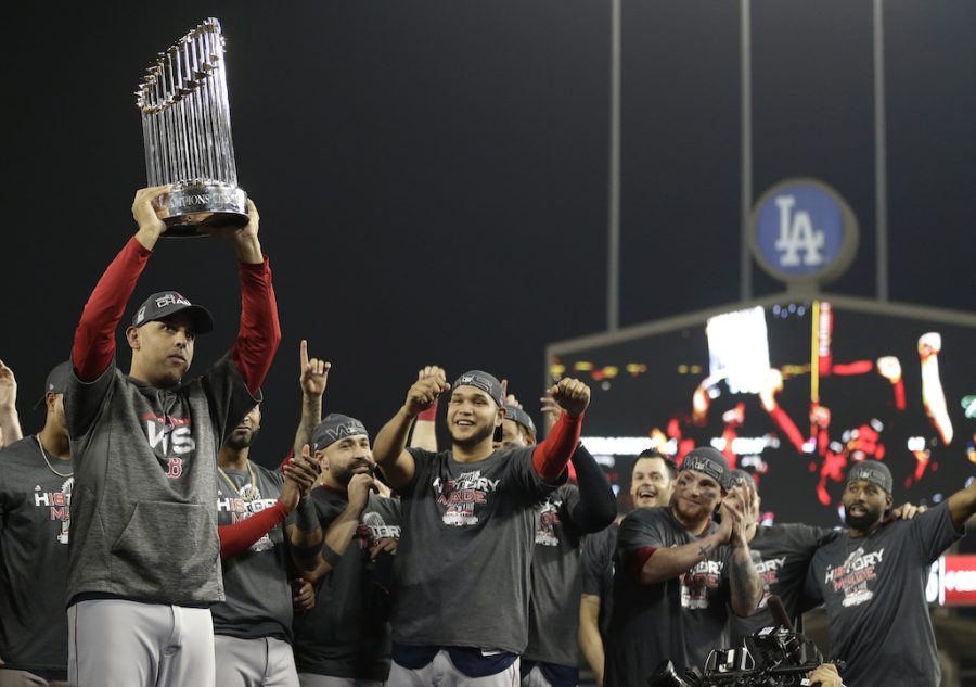 Boston Red Sox manager Alex Cora holds the championship trophy after Game 5 of baseballs World Series against the Los Angeles Dodgers on Sunday, Oct. 28, 2018, in Los Angeles. The Red Sox won 5-1 to win the series 4 game to 1.