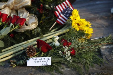 Flowers and a note saying former President George H. W. Bush was one of the good guys, are seen at a makeshift memorial across from Walkers Point, the Bushs summer home, Saturday, Dec. 1, 2018, in Kennebunkport, Maine. Bush died at the age of 94 on Friday, about eight months after the death of his wife, Barbara Bush. (AP Photo/Robert F. Bukaty)