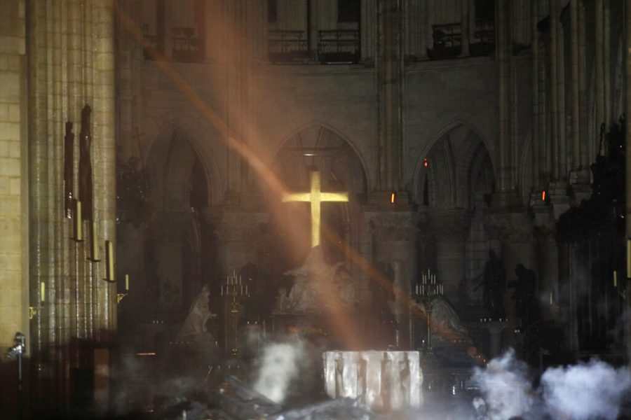 Smoke is seen around the alter inside Notre Dame cathedral in Paris, Monday, April 15, 2019. A catastrophic fire engulfed the upper reaches of Paris soaring Notre Dame Cathedral as it was undergoing renovations Monday, threatening one of the greatest architectural treasures of the Western world as tourists and Parisians looked on aghast from the streets below. (Philippe Wojazer/Pool via AP)