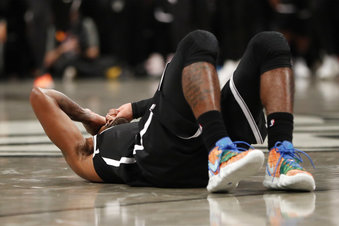 Brooklyn Nets guard Kyrie Irving (11) lies on the floor after failing to score in the waning seconds of overtime of an NBA basketball game Wednesday, Oct. 23, 2019, in New York. The Timberwolves defeated the Nets 127-126. Irving had 50 points. (AP Photo/Kathy Willens)