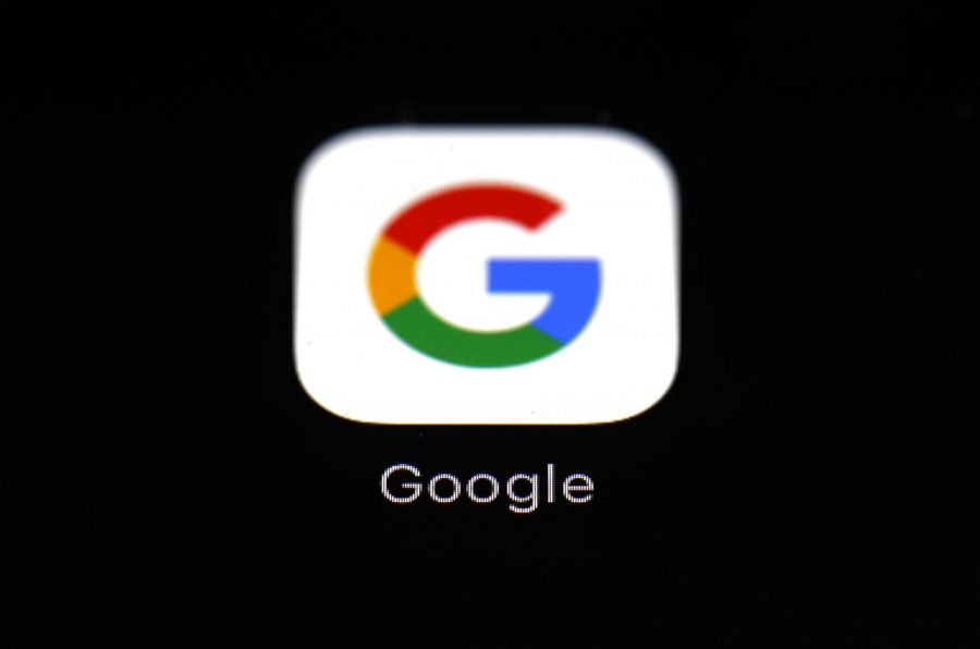 FILE - This March 19, 2018 file photo shows a Google app in Baltimore. Apple and Google launched a major joint effort, Friday, April 10, 2020, to leverage smartphone technology contain the COVID-19 pandemic. New software the companies plan to add to phones would make it easier to use Bluetooth wireless technology to track down people who may have been infected by coronavirus carriers.(AP Photo/Patrick Semansky, File)