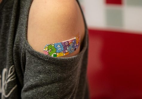 A bandage is placed on Mackenzie Olson, 10, after receiving her COVID-19 vaccination at a pediatricians office on Wednesday, Nov. 3, 2021, in Decatur, Ga. The U.S. enters a new phase Wednesday in its COVID-19 vaccination campaign, with shots now available to millions of elementary-age children in what health officials hailed as a major breakthrough after more than 18 months of illness, hospitalizations, deaths and disrupted education. (AP Photo/Ron Harris)