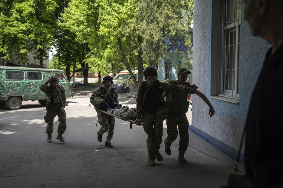 Ukrainian servicemen carry an injured comrade on A stretcher to the hospital after an attack by Russian forces in
Donetsk region, Ukraine, on Monday, May 9, 2022. (AP Photo/Evgeniy Maloletka)