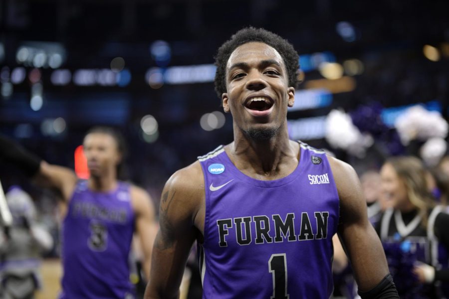 Furman guard JP Pegues (1) celebrates while leaving the court after their win against Virginia in a first-round college basketball game in the NCAA Tournament, Thursday, March 16, 2023, in Orlando, Fla. (AP Photo/Phelan M. Ebenhack)