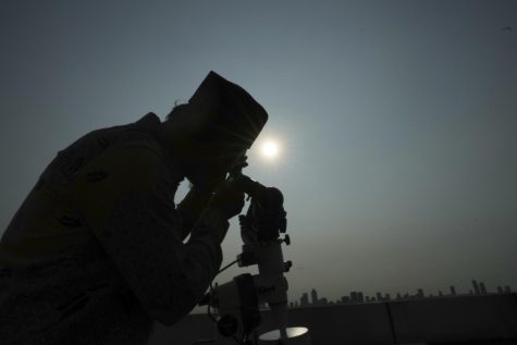 An official is silhouetted as he uses a telescope to scan the horizon for a crescent moon that will determine the beginning of the holy fasting month of Ramadan in Jakarta, Indonesia, Wednesday, March. 22, 2023. Millions of Muslims in Indonesia are gearing up to celebrate the holy month of Ramadan, which is expected to start on Thursday, with traditions and ceremonies across the worlds most populous Muslim-majority country amid soaring food prices.(AP Photo/Achmad Ibrahim)