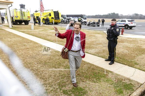 Alabama football head coach Nick Saban waves to the fans as the University of Alabama football team arrives home at the Tuscaloosa National Airport after winning the 2021 College Football Playoff national championship, Tuesday, Jan. 12, 2021, in Tuscaloosa, Ala. (AP Photo/Vasha Hunt)