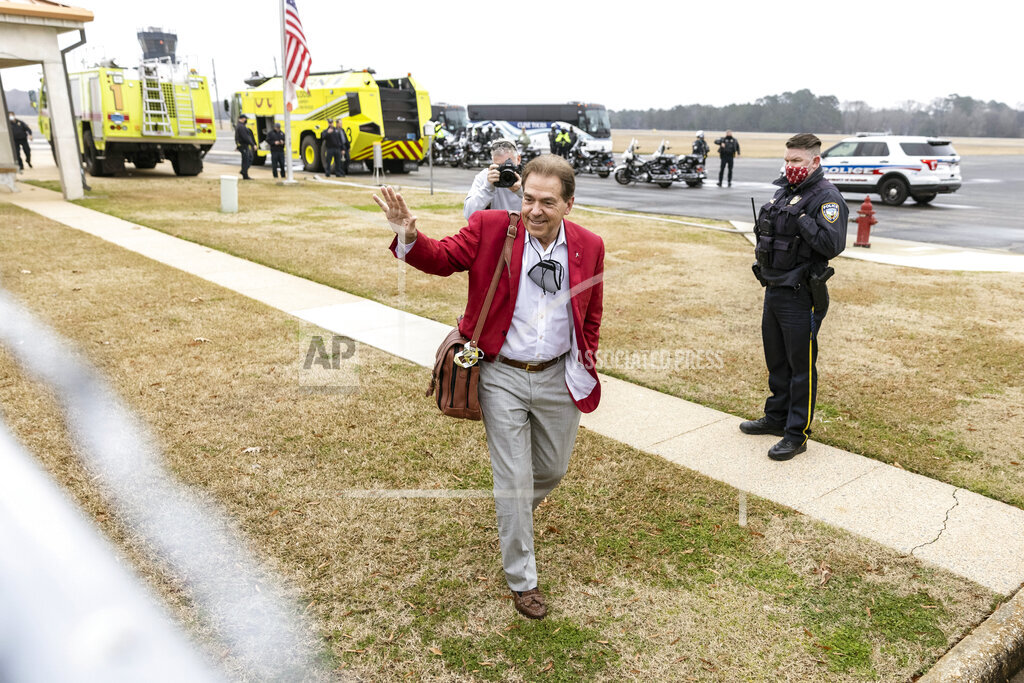 Alabama football head coach Nick Saban waves to the fans as the University of Alabama football team arrives home at the Tuscaloosa National Airport after winning the 2021 College Football Playoff national championship, Tuesday, Jan. 12, 2021, in Tuscaloosa, Ala. (AP Photo/Vasha Hunt)