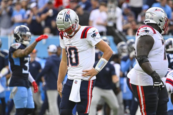 New England Patriots quarterback Drake Maye (10) is sacked by Tennessee Titans defensive tackle Sebastian Joseph-Day (69) and linebacker Harold Landry III (58) during the first half of an NFL football game in Nashville, Tenn., Sunday, Nov. 3, 2024. (AP Photo/George Walker IV))