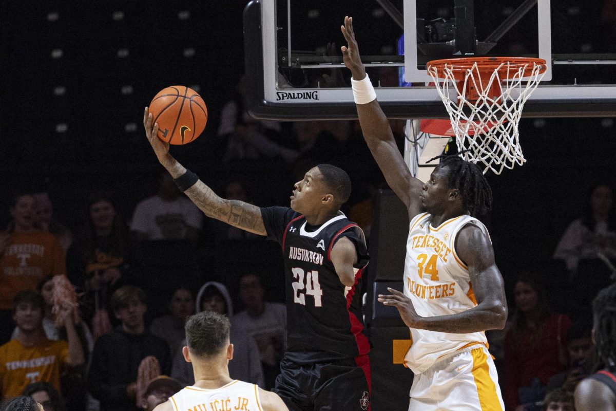 Austin Peay guard Hansel Enmanuel (24) shoots past Tennessee forward Felix Okpara (34) during the second half of an NCAA college basketball game Sunday, Nov. 17, 2024, in Knoxville, Tenn. (AP Photo/Wade Payne)