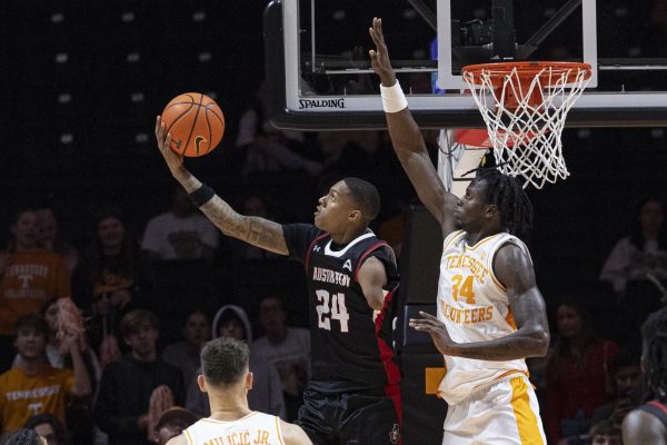 Austin Peay guard Hansel Enmanuel (24) shoots past Tennessee forward Felix Okpara (34) during the second half of an NCAA college basketball game Sunday, Nov. 17, 2024, in Knoxville, Tenn. (AP Photo/Wade Payne)